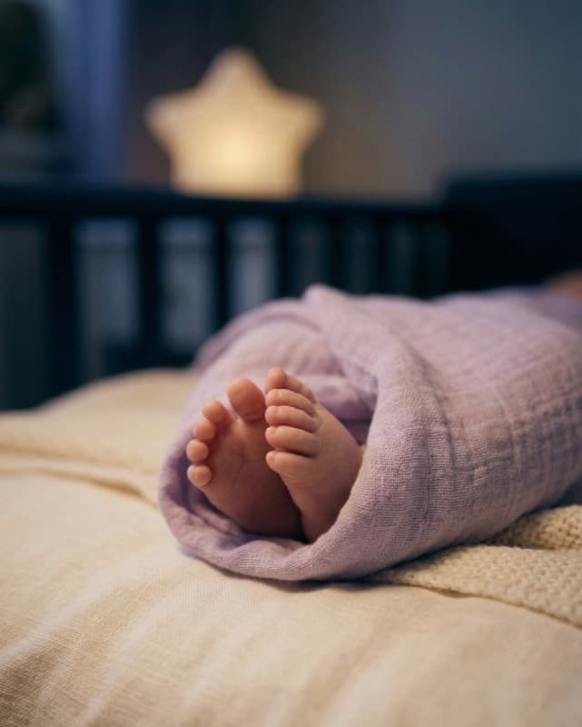 Sleeping baby wrapped in a blanket